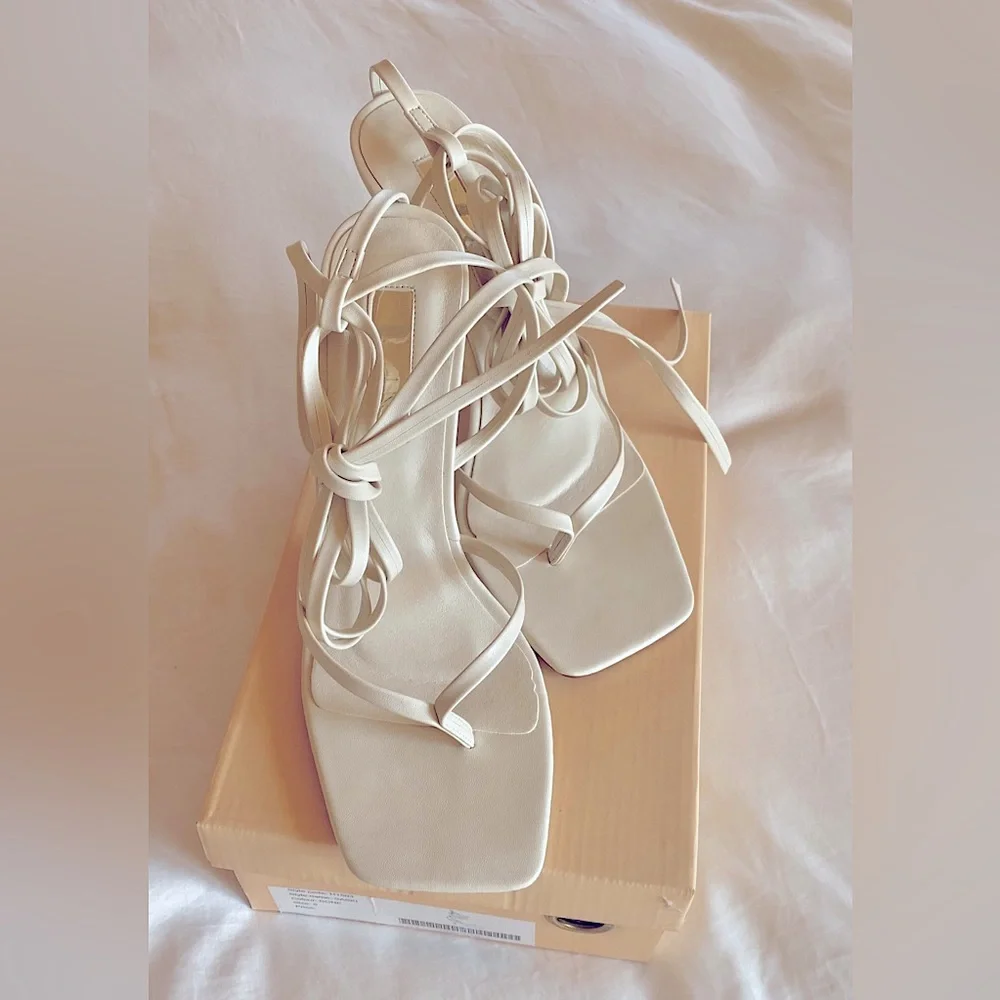 Saski by Billini is a modern, strappy heel. In the SOLD OUT color bone. - Picture 1 of 5